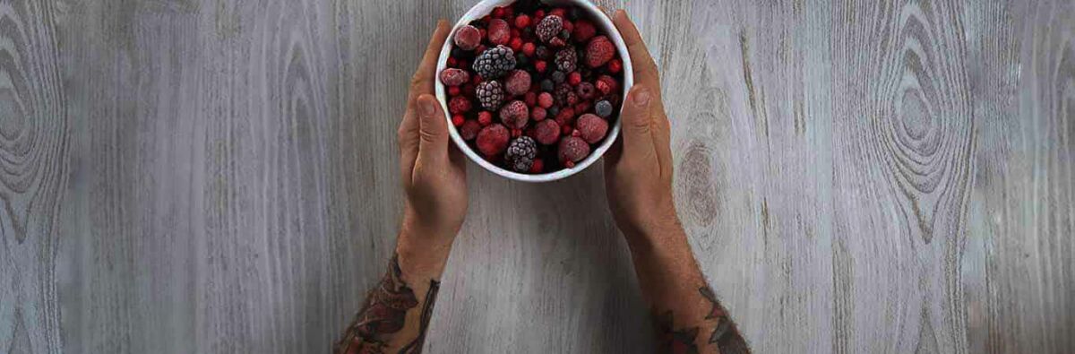 Man holding a bowl of berries